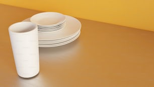 a stack of white plates sitting on top of a wooden table