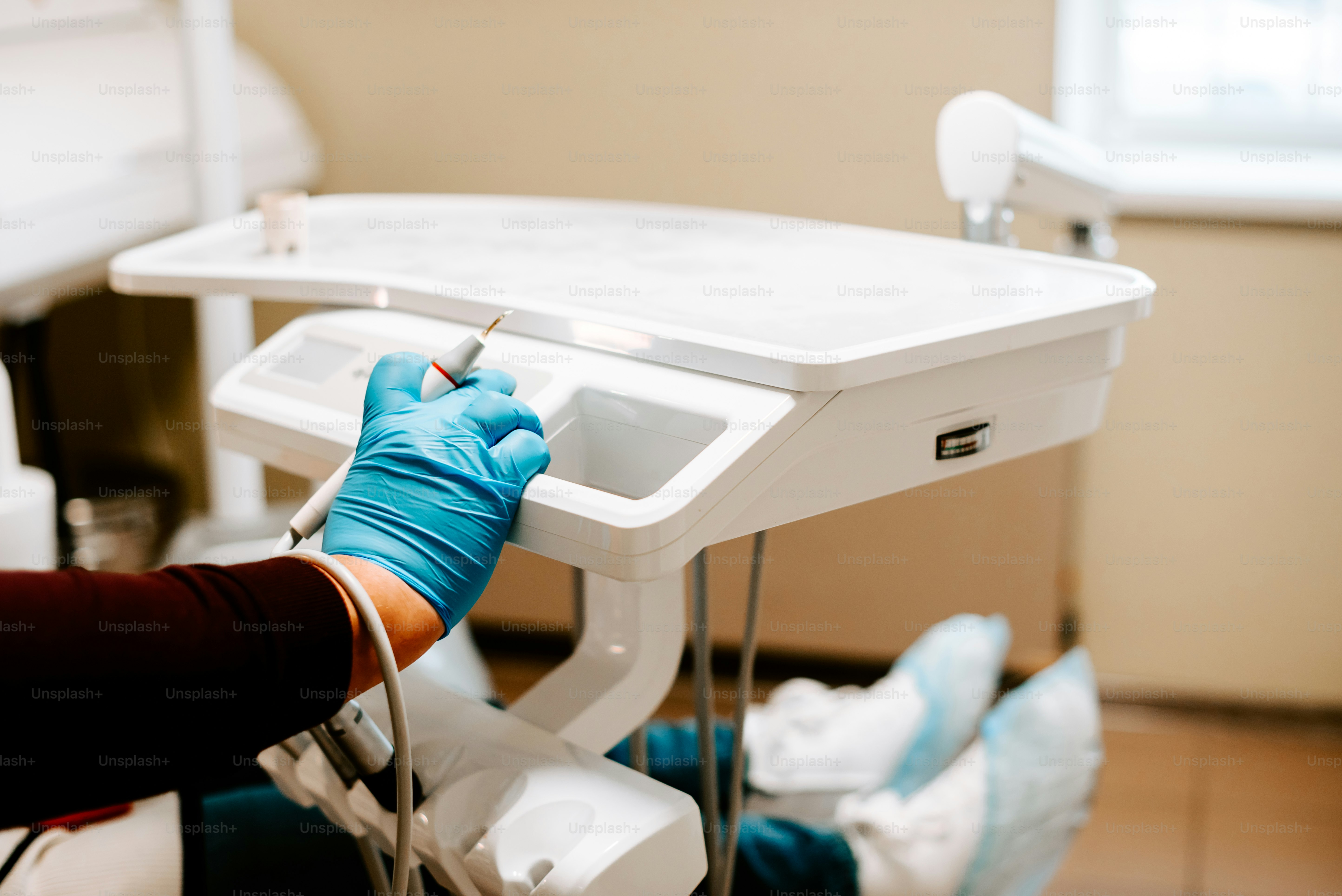 a person in blue gloves and blue gloves on a table