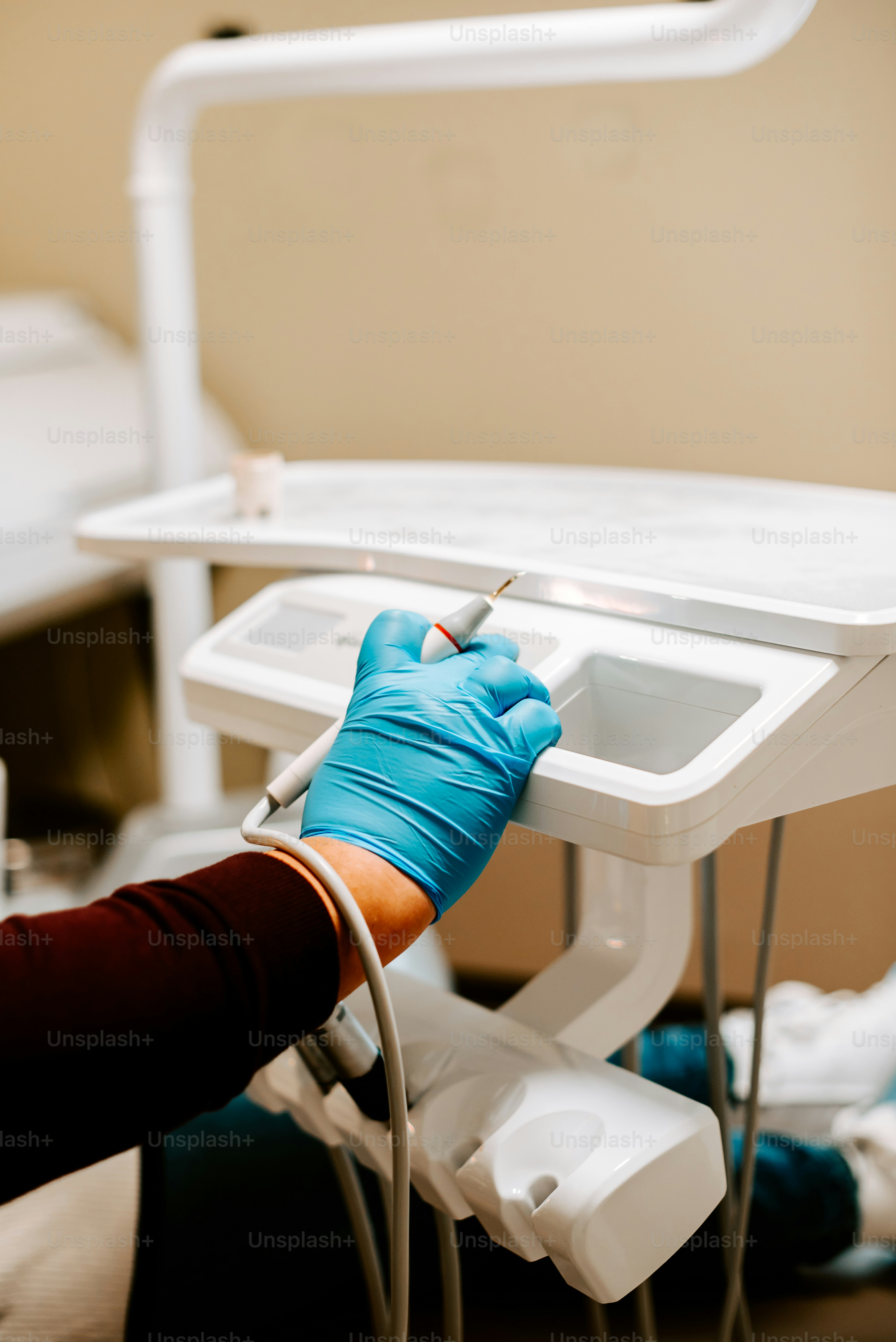 a person in blue gloves and gloves writing on a white table