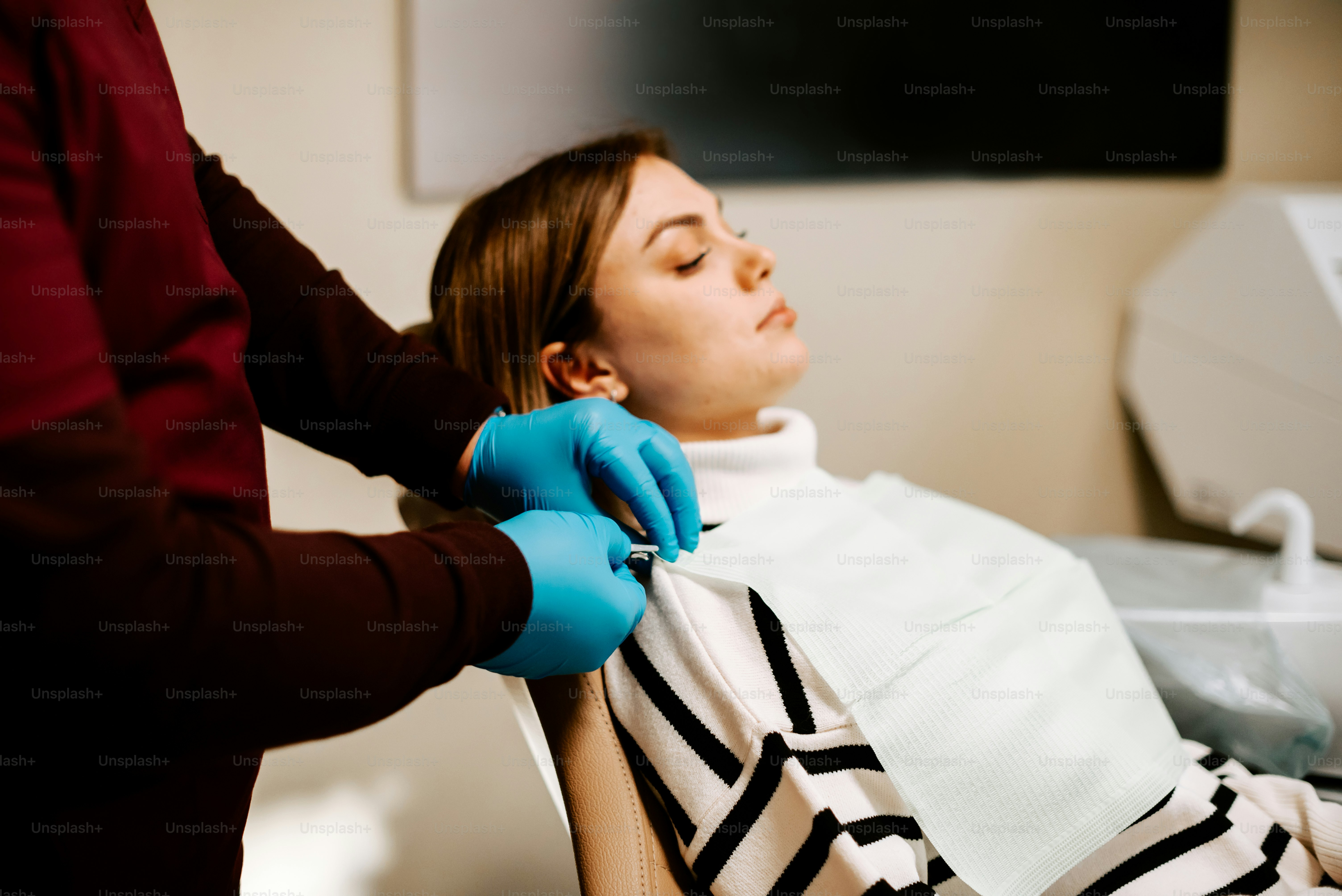 a woman getting her hair cut by a hair stylist