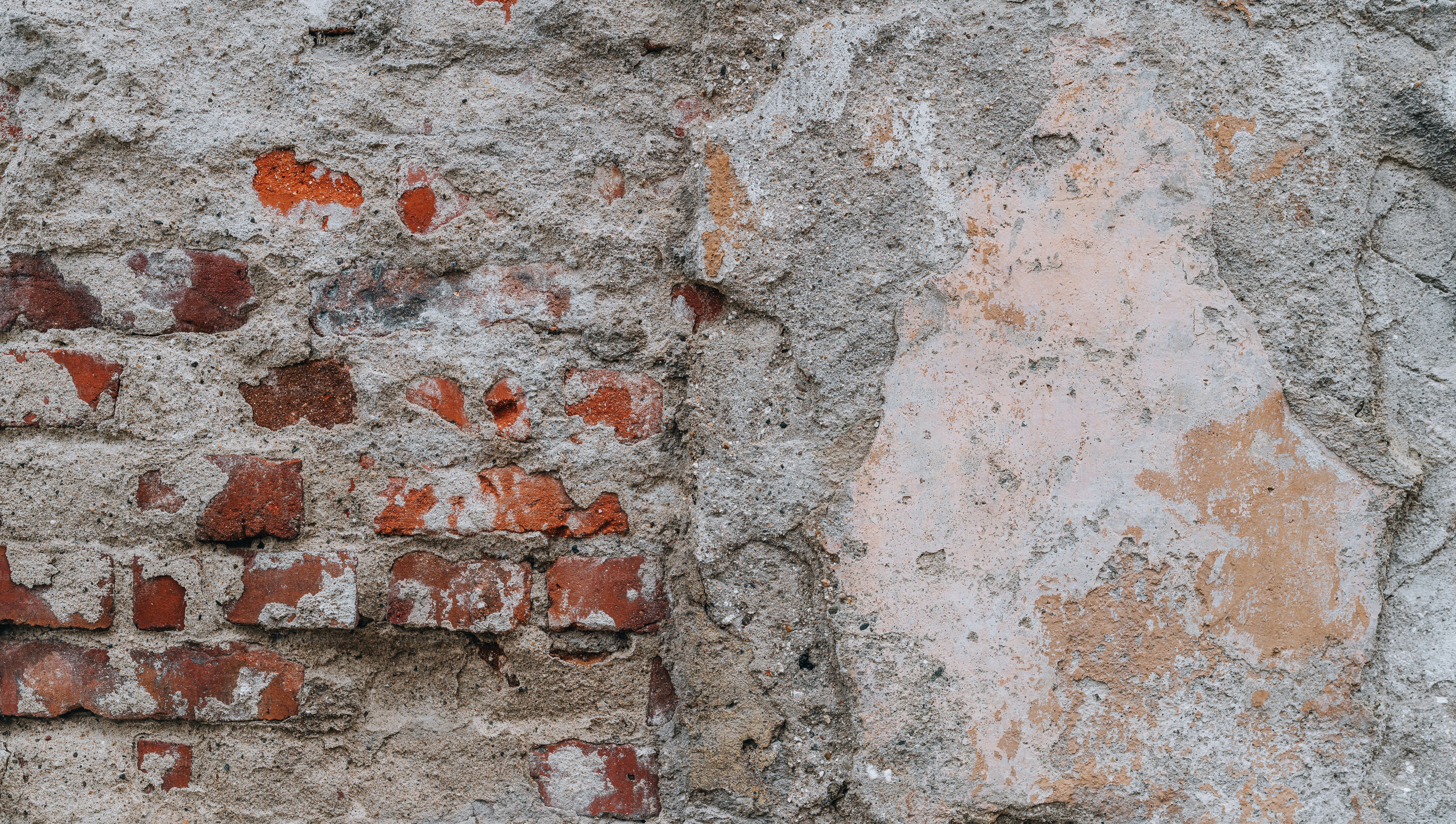 an old brick wall with a clock on it