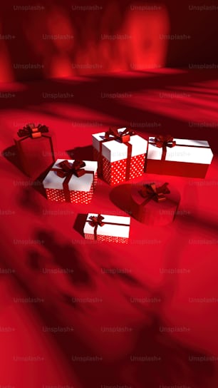 three red and white gift boxes on a red surface