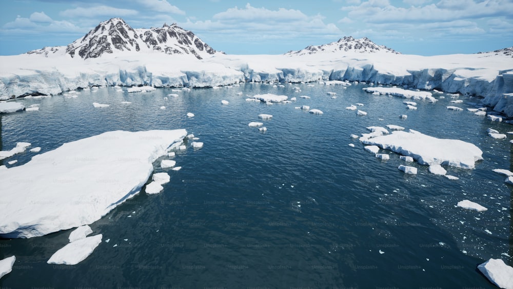 a large body of water surrounded by snow covered mountains