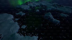 an aerial view of the ocean with icebergs and aurora lights