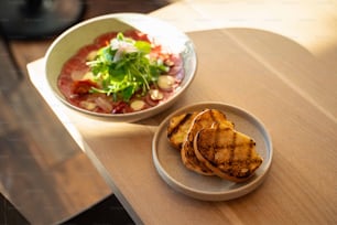 a bowl of soup and a plate of food on a table