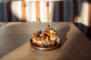 a wooden table topped with a plate of food
