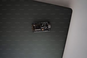 a close up of a laptop computer with a micro board attached to it