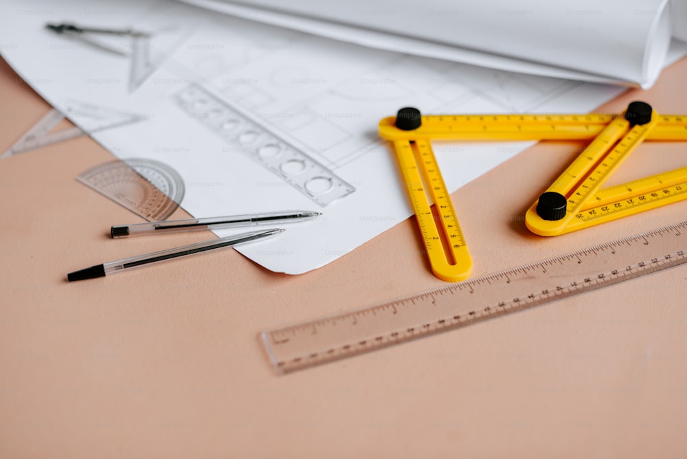 a ruler, rulers, and a pair of scissors on a table