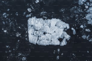 an aerial view of ice chunks floating in the water