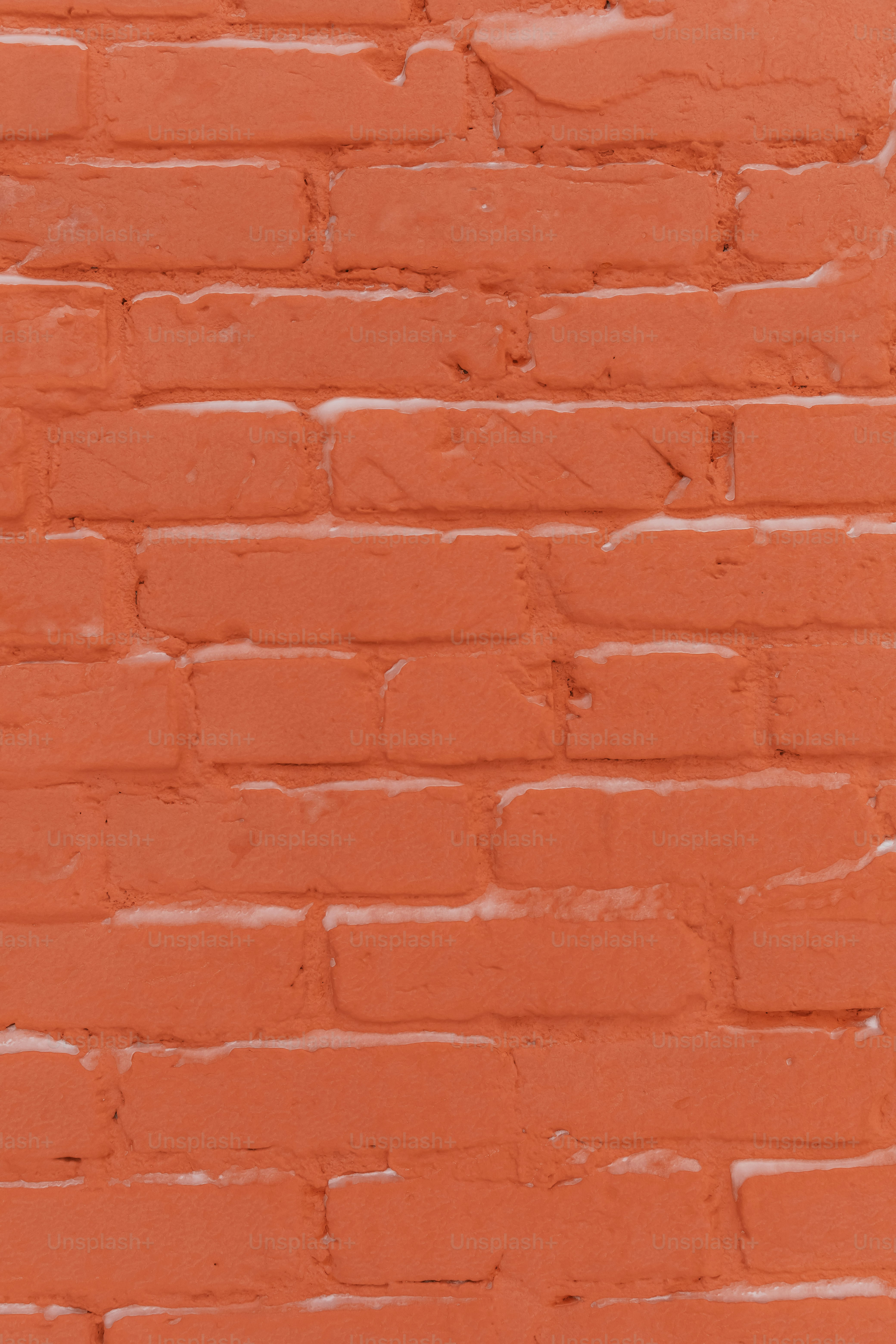 a red brick wall with a clock on it