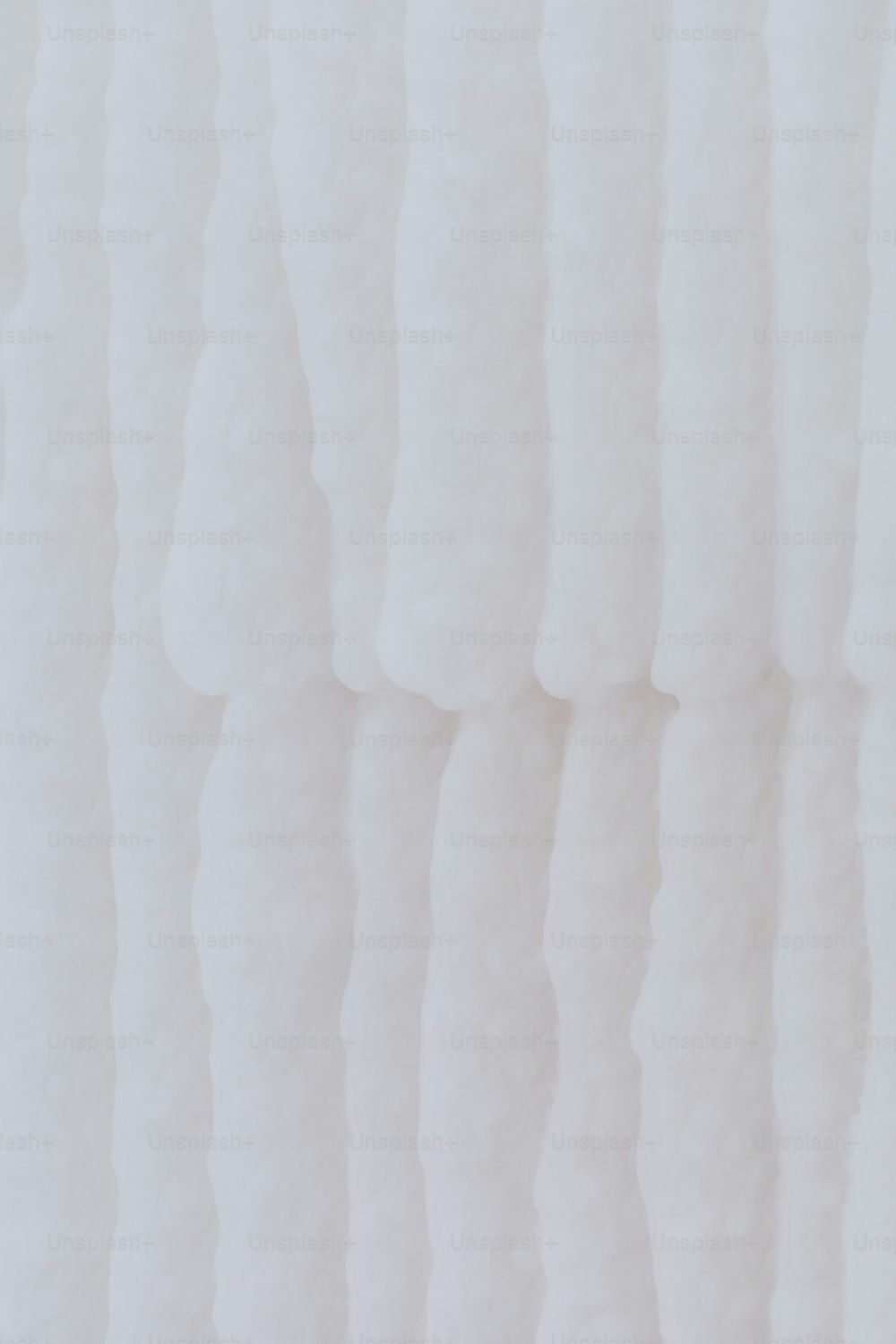 a close up of a white wall with wavy lines