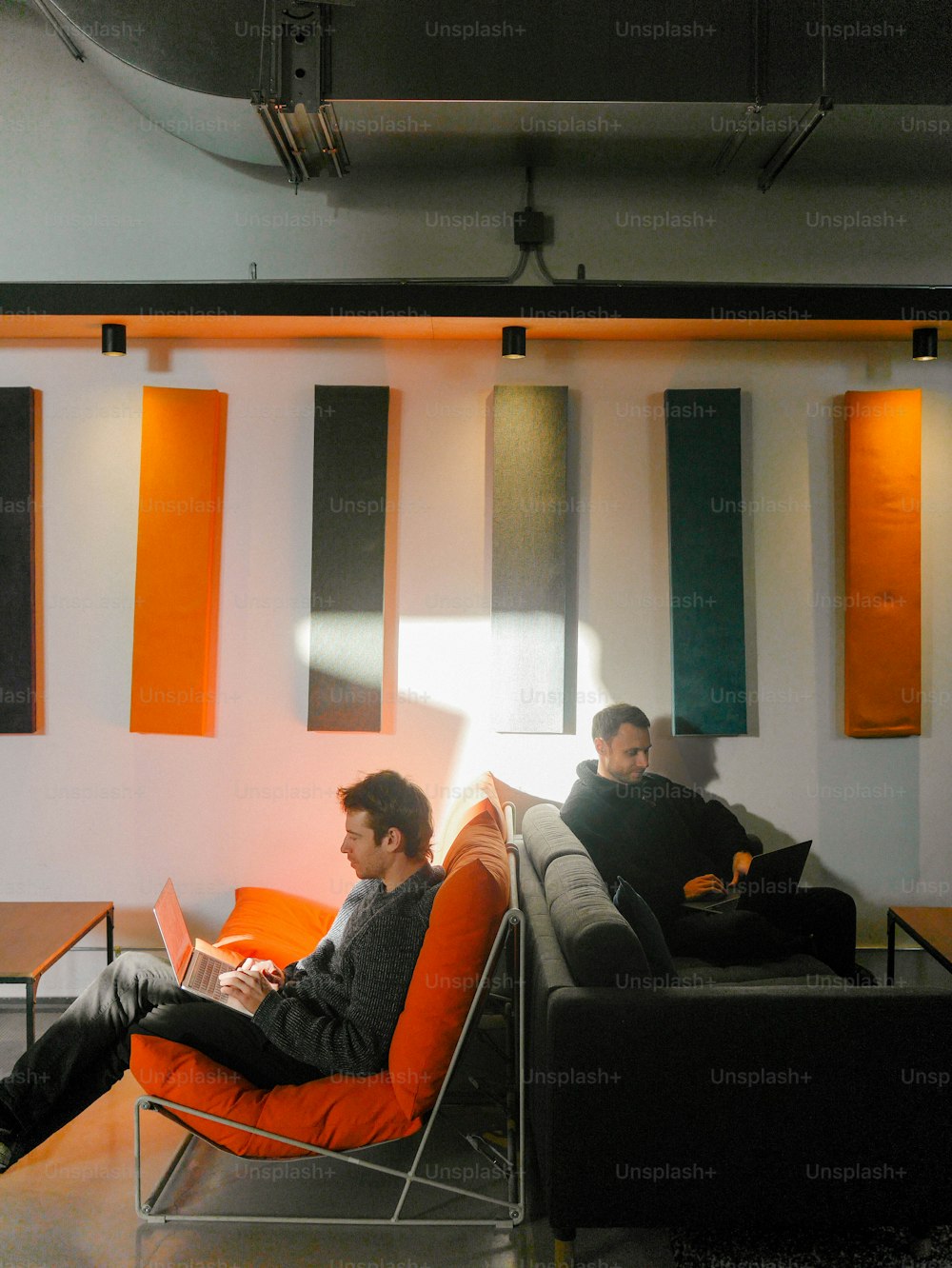 a couple of men sitting on top of a couch