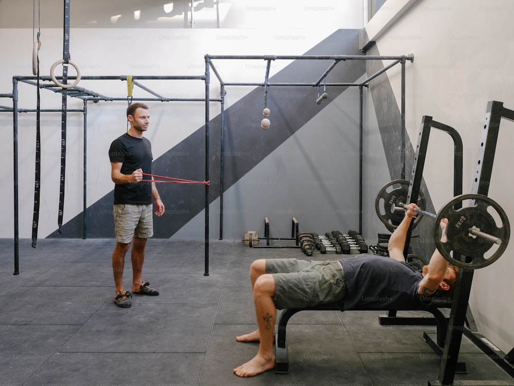 a man doing a deadlift with a barbell