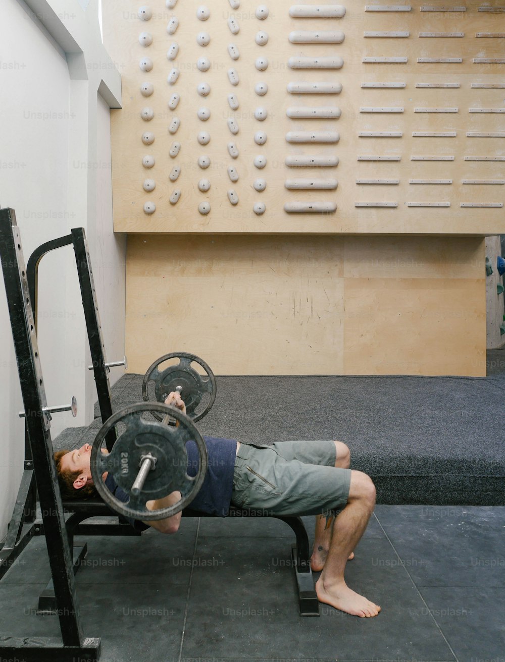 a man doing a bench press with a barbell
