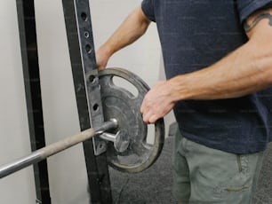 a man holding onto a pulley in a gym