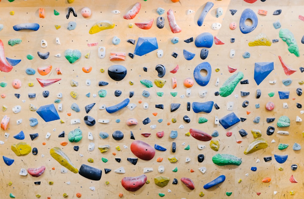 a climbing wall with a variety of colorful rocks