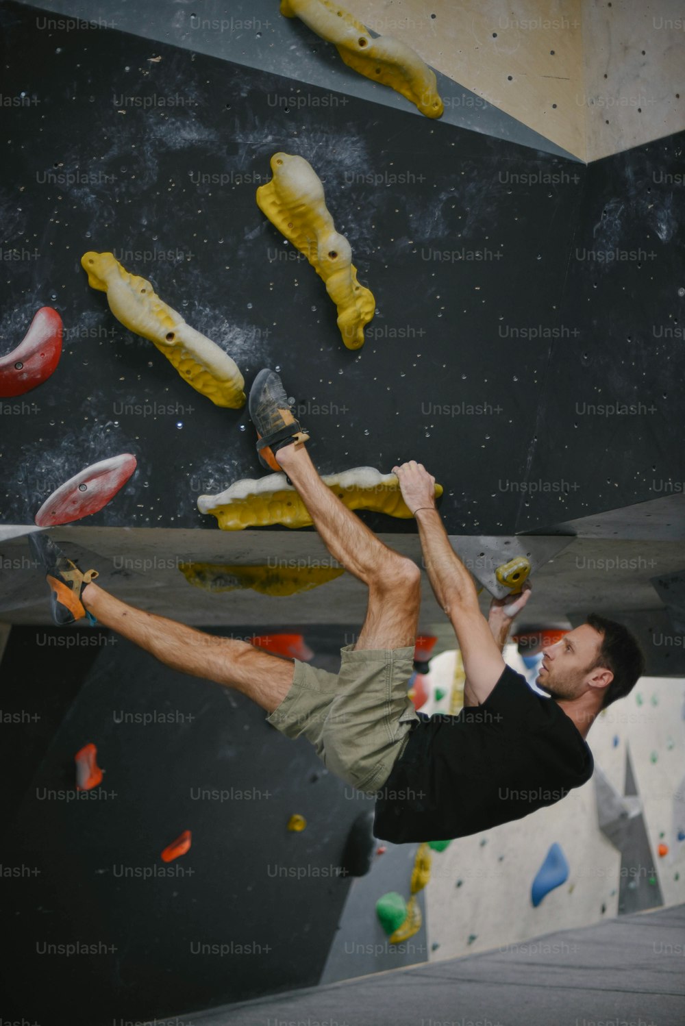 a man on a climbing wall doing a trick