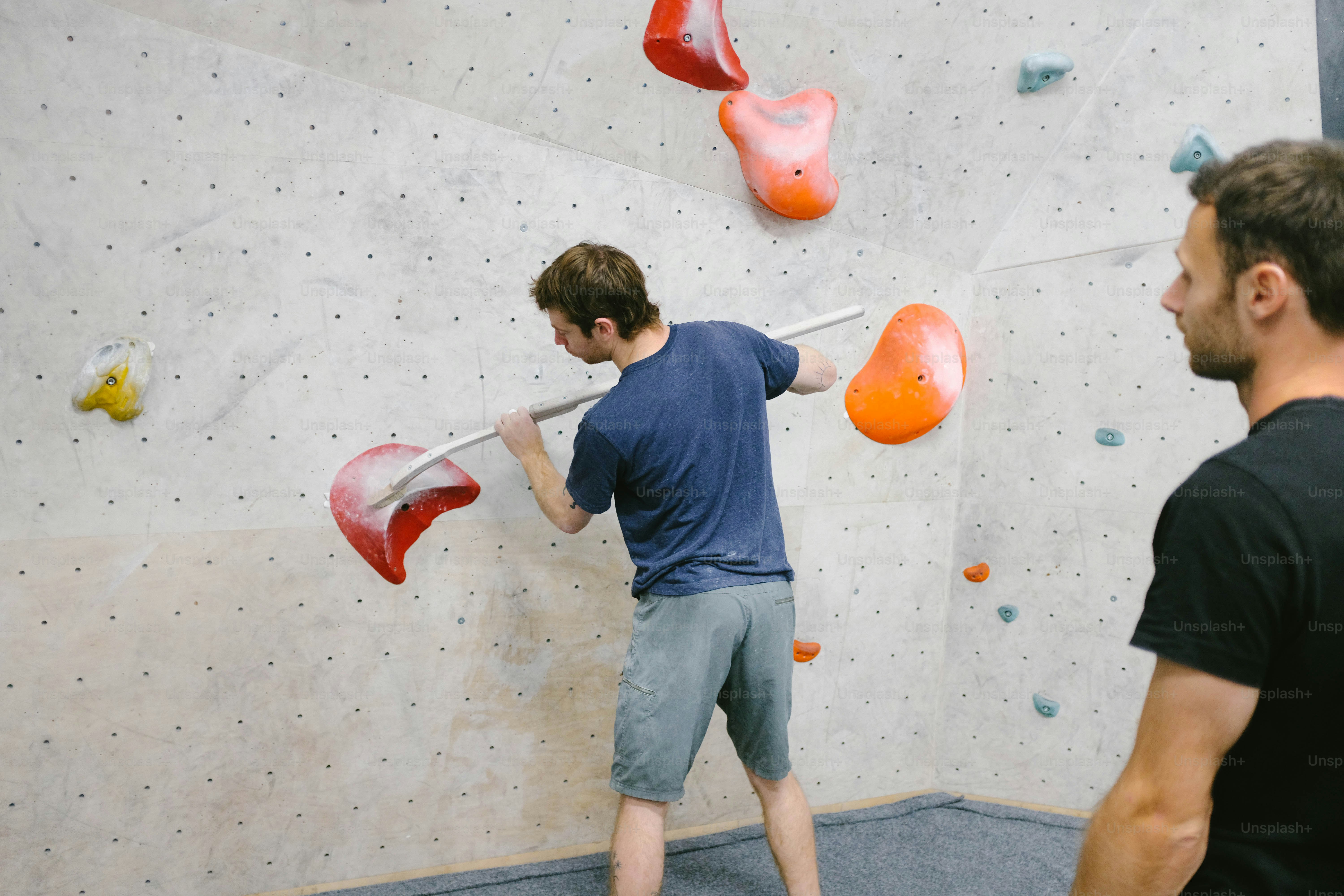 a man is climbing on a climbing wall