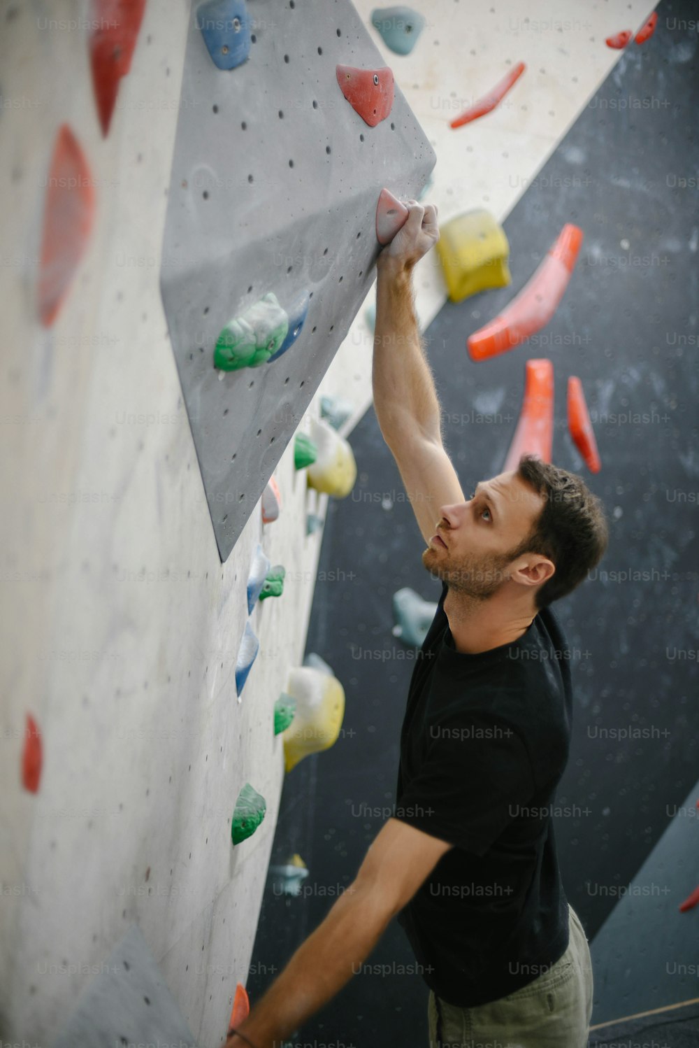 a man climbing up the side of a rock wall