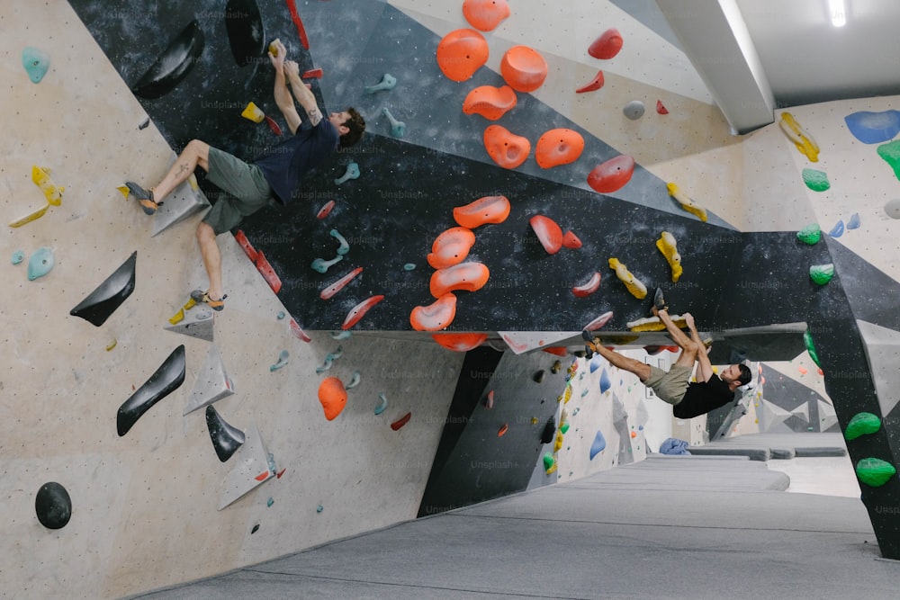 a couple of people on a climbing wall