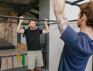 a man holding a bar in front of another man