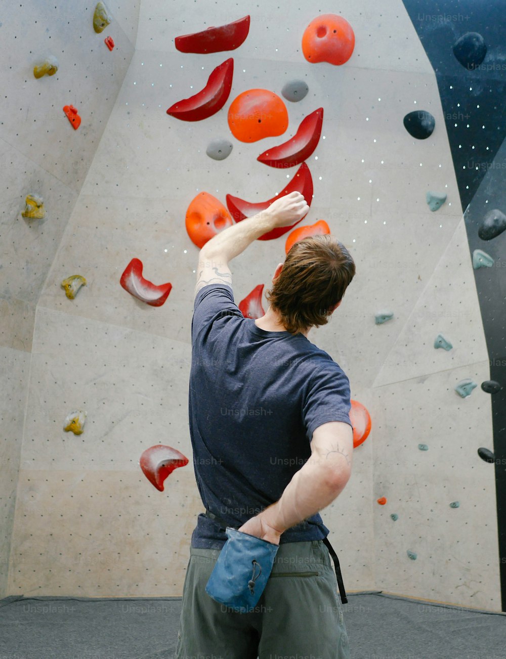 a man is climbing up a rock wall