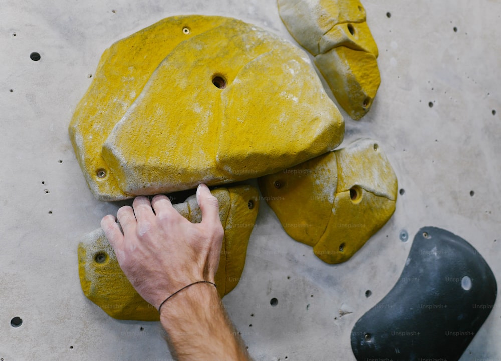 a man is working on some yellow rocks