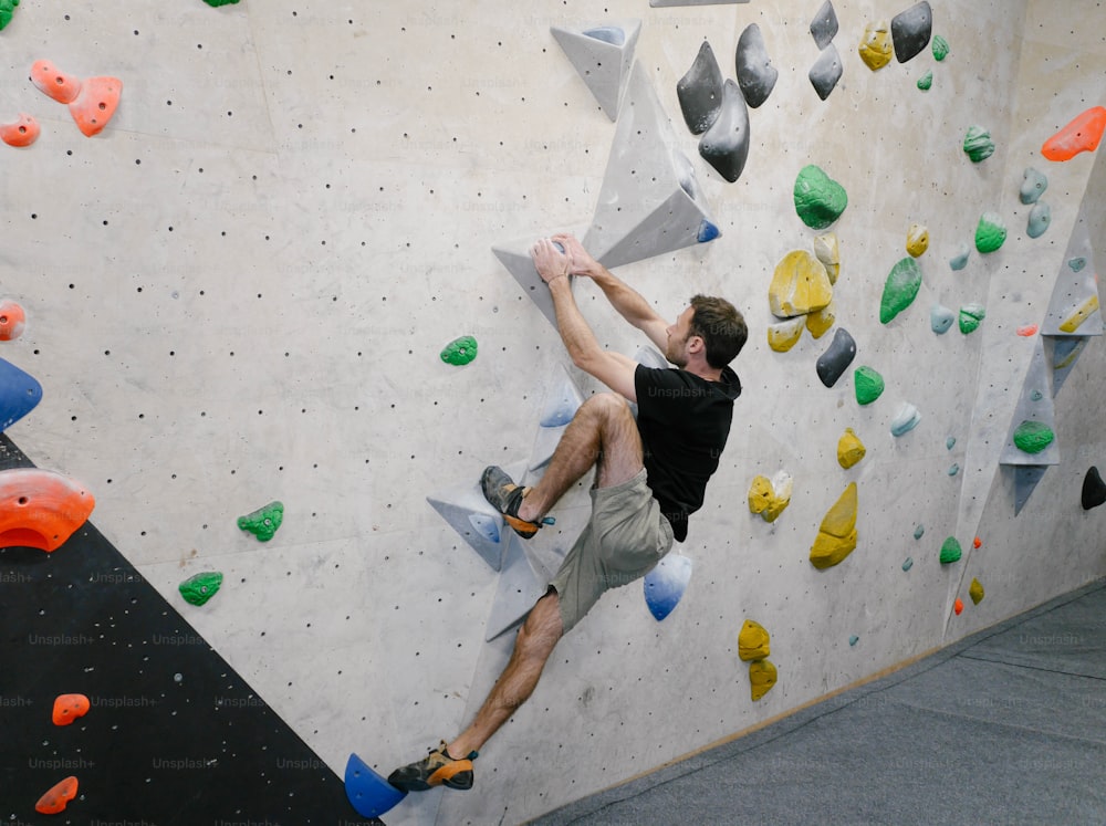 um homem escalando o lado de uma parede de rocha
