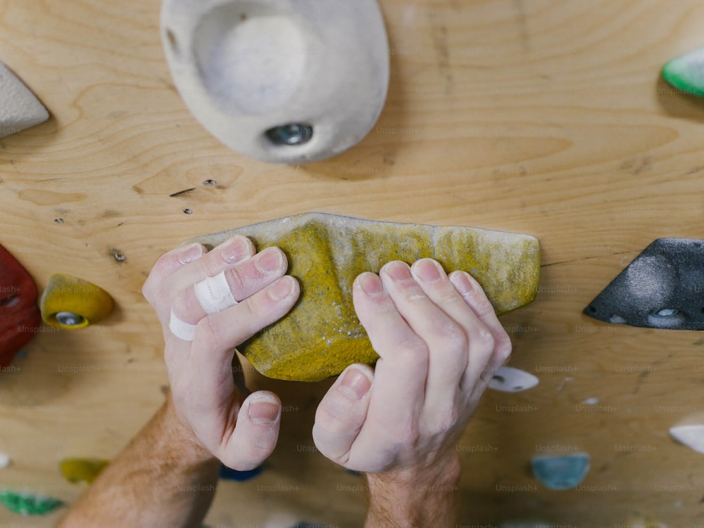 a man working on a piece of art on a table