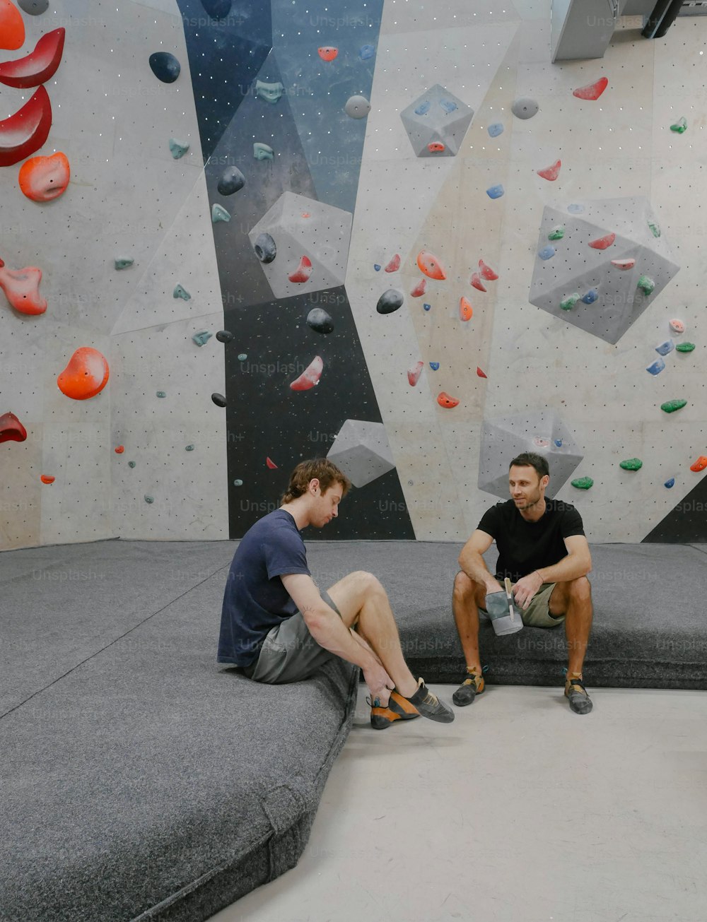 a couple of men sitting on top of a couch