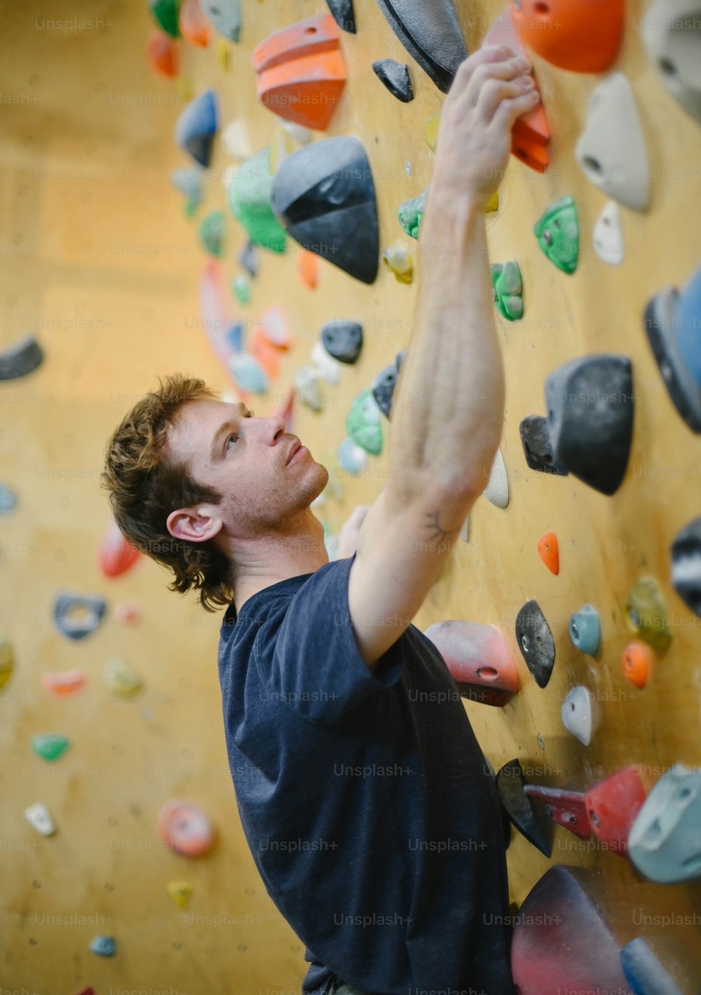 a man climbing up the side of a rock wall