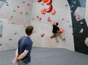 a man is climbing on a climbing wall