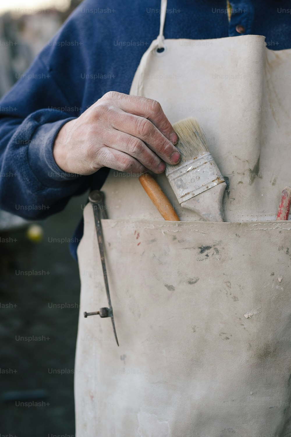 a person holding a paintbrush in their hand