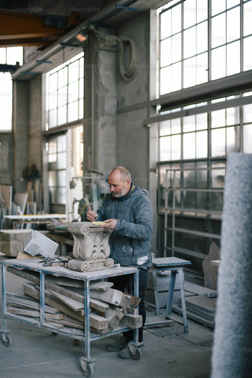 a man working on a sculpture in a factory