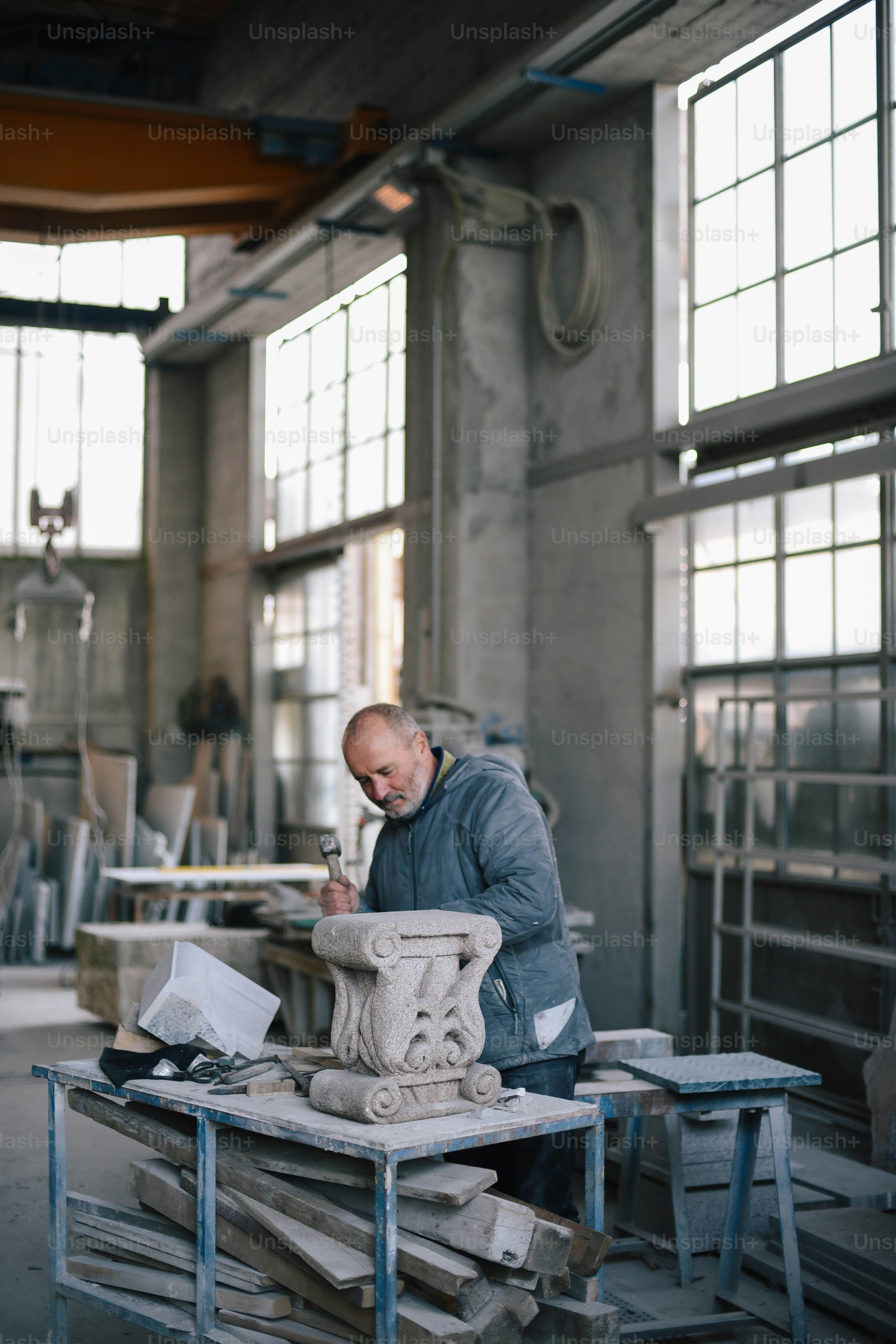 a man working on a sculpture in a factory