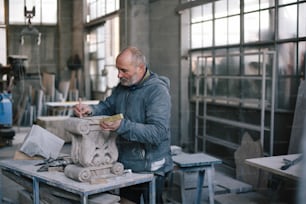 工場で彫刻に取り組んでいる男性