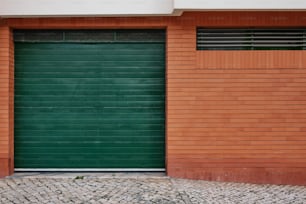 a fire hydrant in front of a green garage door