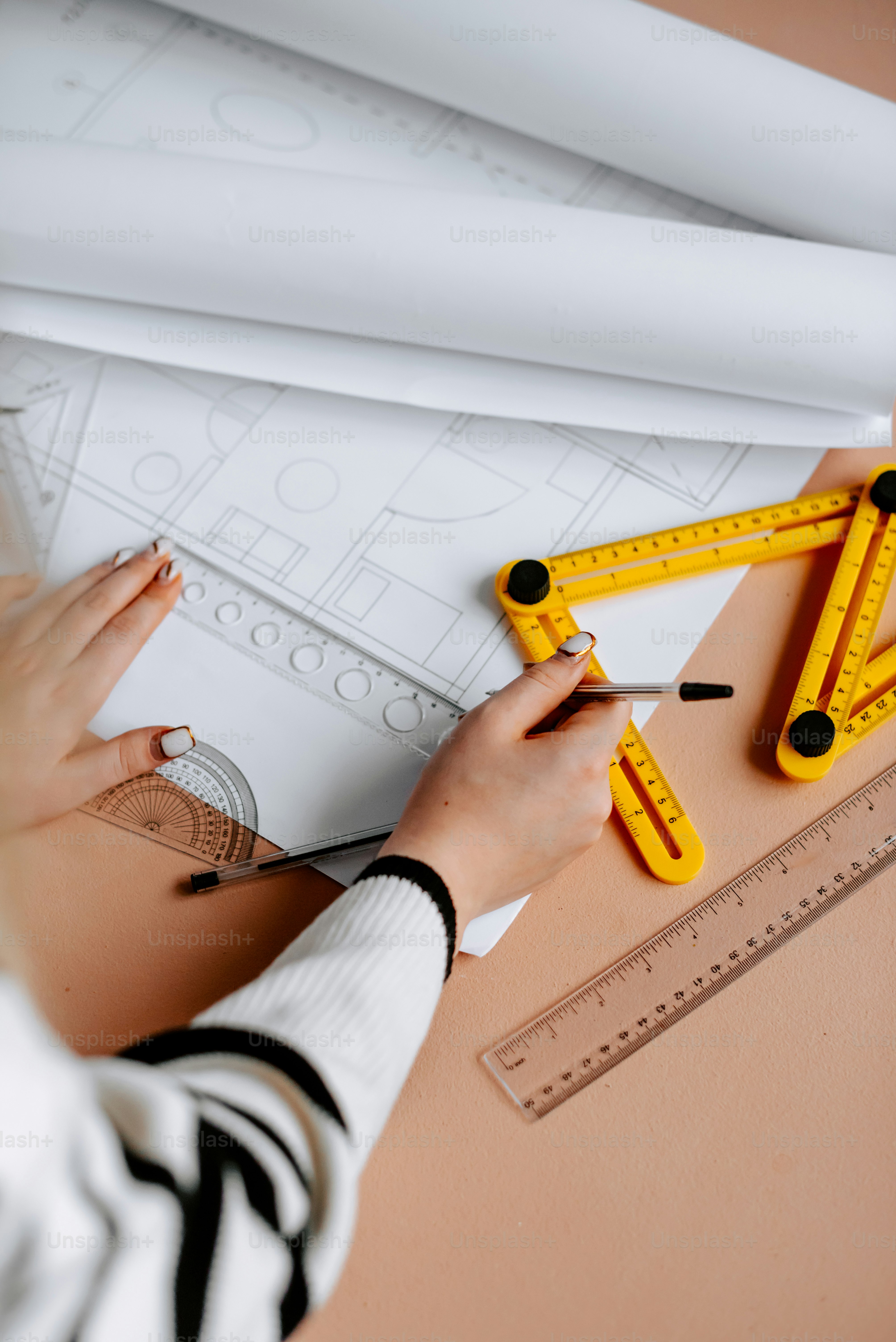 a woman is drawing on a piece of paper