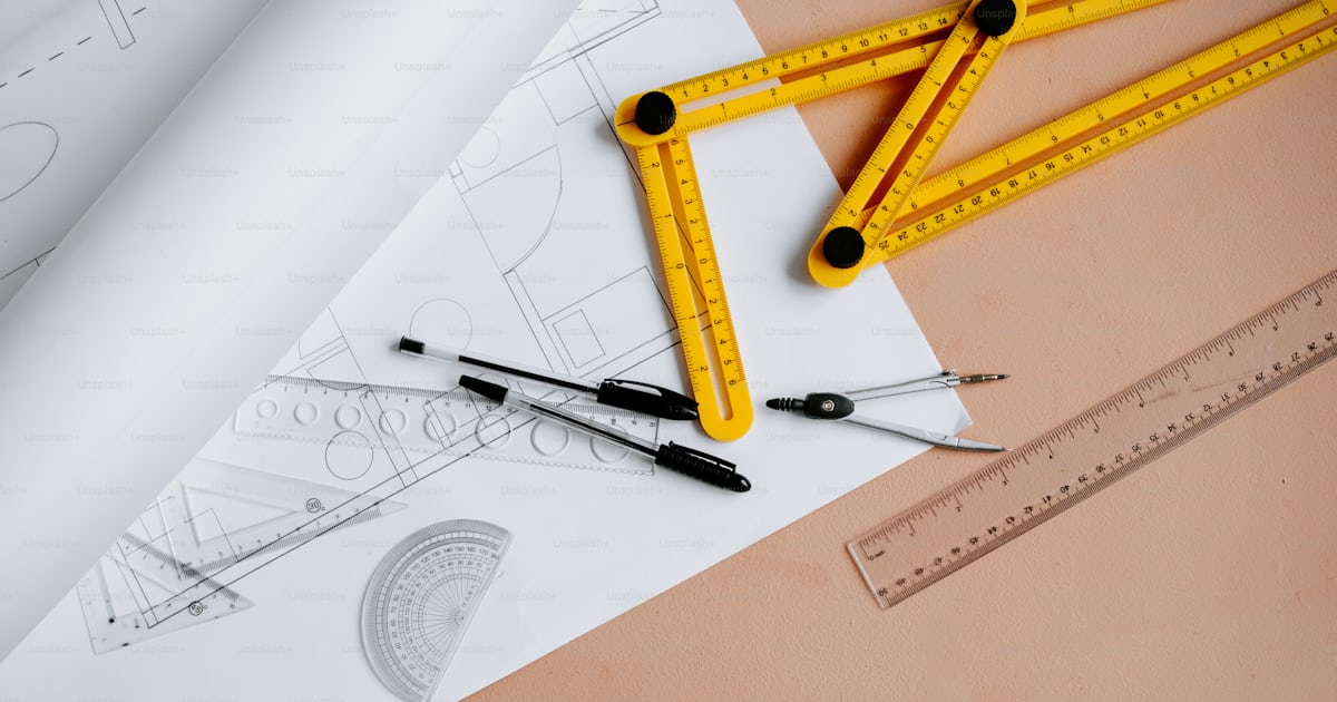 A ruler, rulers, and a pair of scissors on a piece of paper photo ...