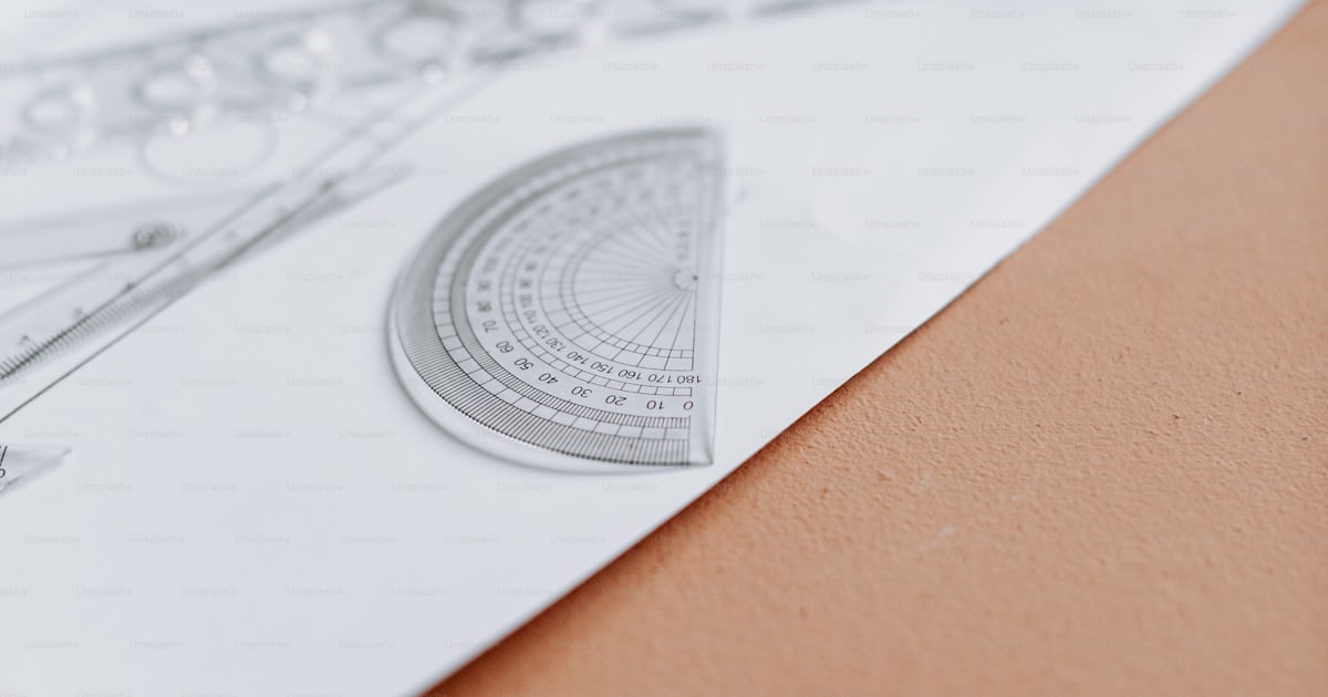 A pair of scissors and a ruler on top of a piece of paper photo ...