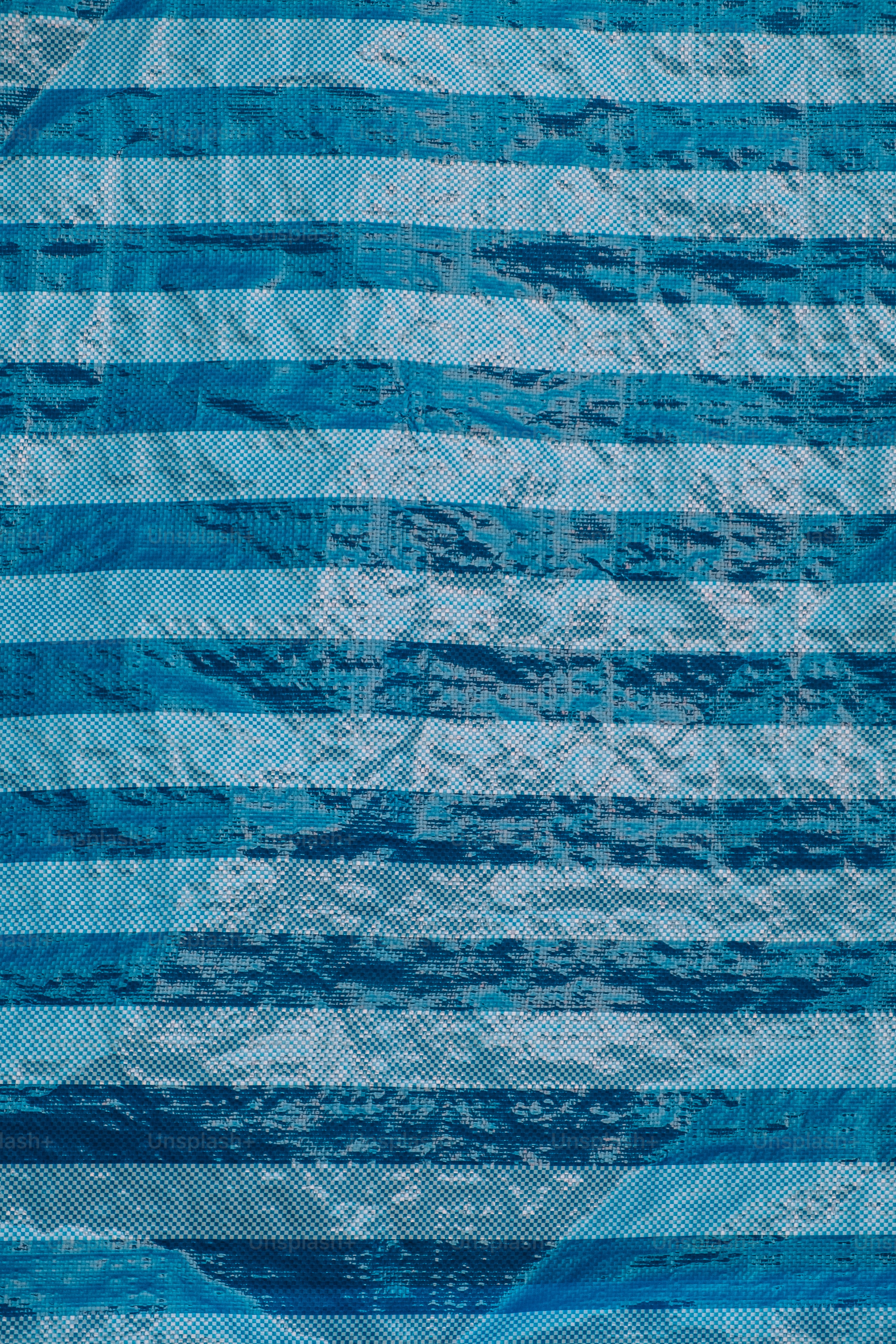 a blue and white striped quilt on a bed
