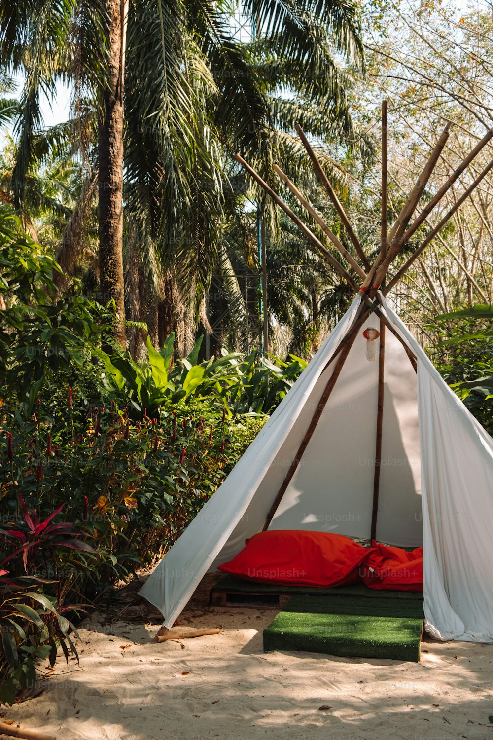 a teepee is set up in the middle of a jungle