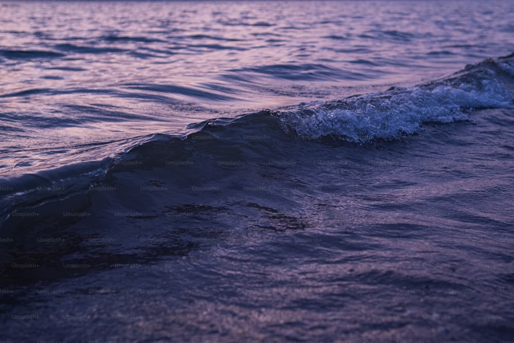 a person riding a surfboard on a wave in the ocean