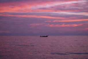 a small boat floating on top of a large body of water