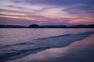 a view of the ocean at sunset from the beach