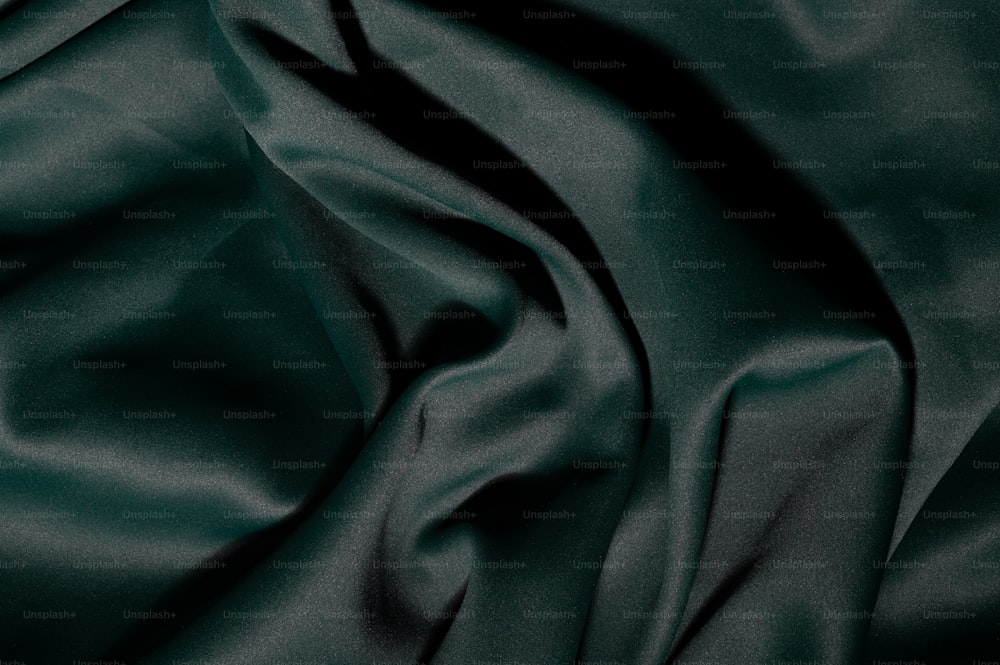 a close up view of a dark green fabric