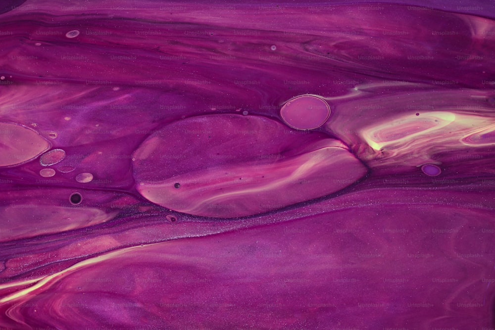 a close up of a purple and yellow liquid
