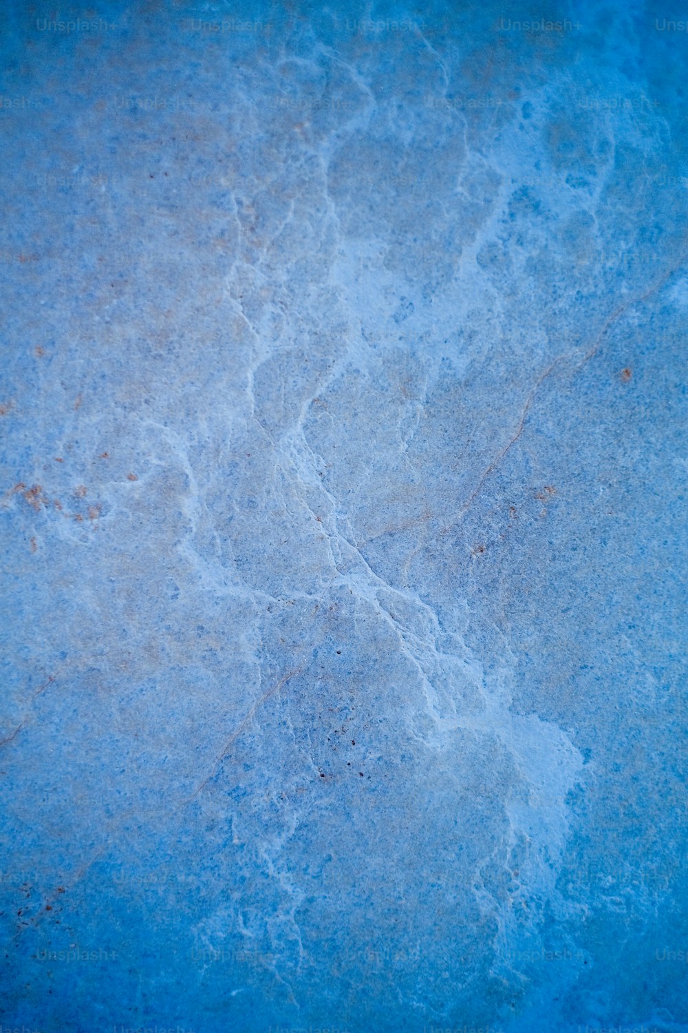 a close up of a blue surface with water