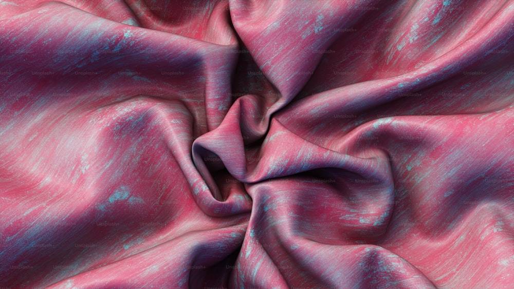 a close up of a pink and blue fabric