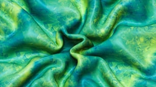 a green and blue fabric with a circular design